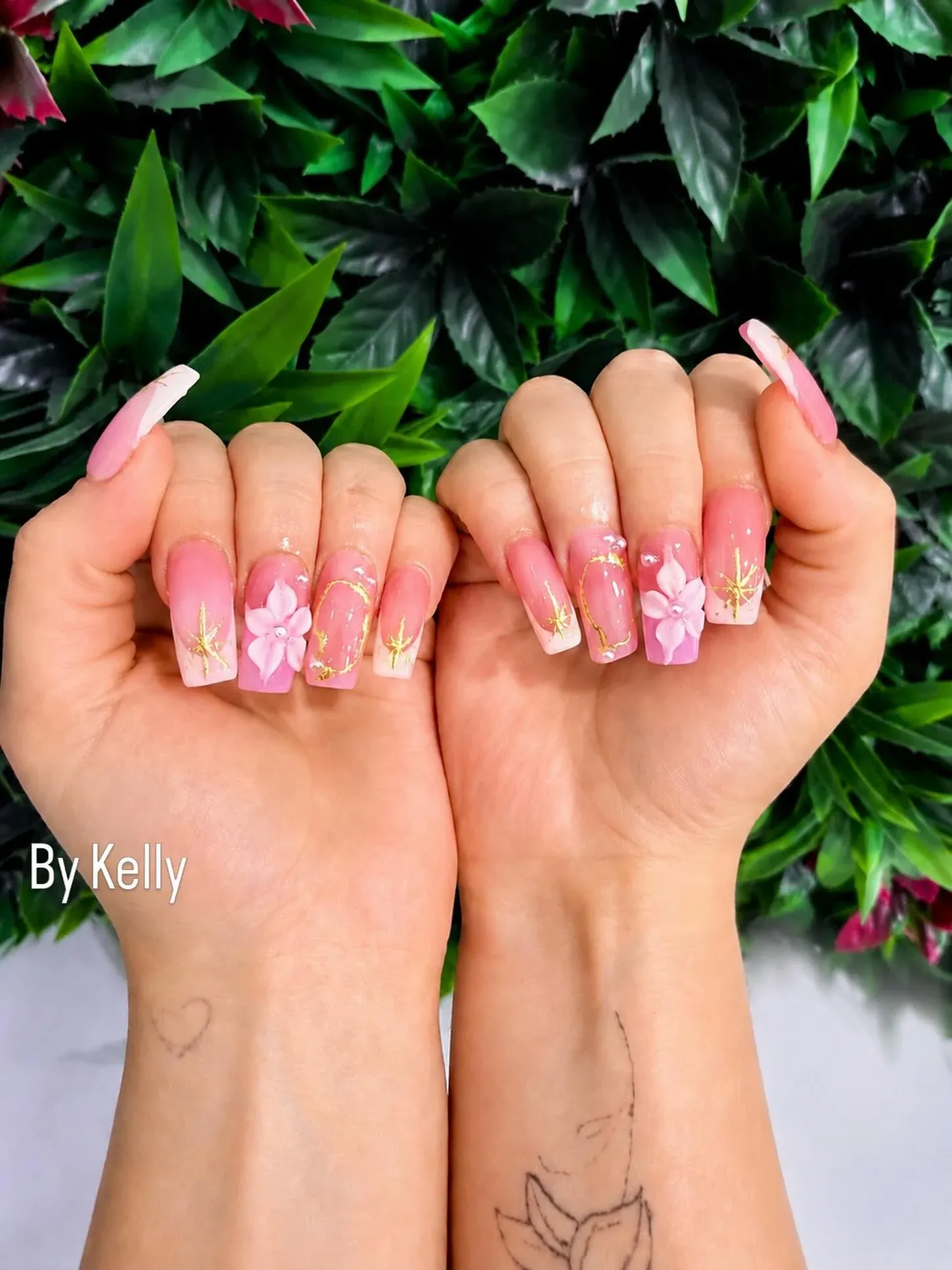 Coffin nails in pink ombre with hand-sculpted 3D pink flowers and gold chrome accents