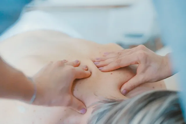 Therapist performing a relaxation shoulder and upper-back massage