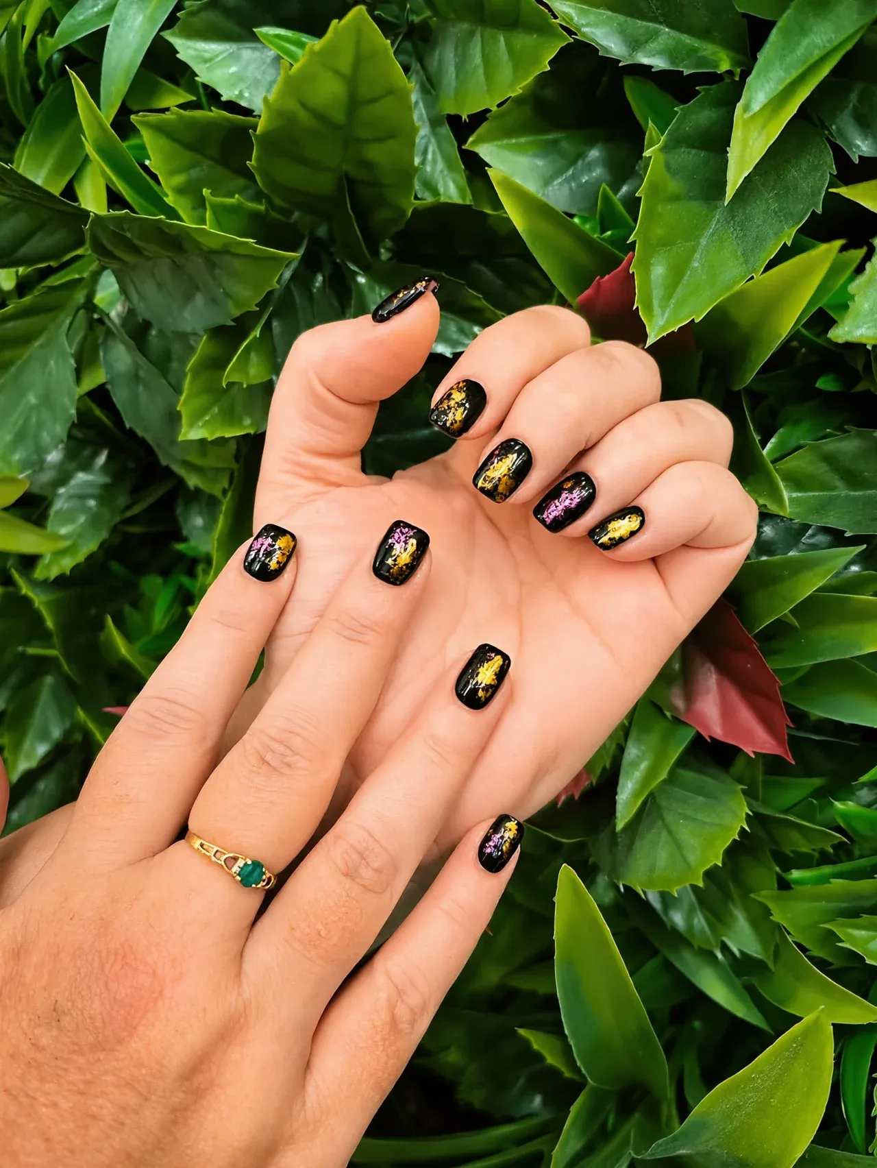 Black nails flecked with gold and pink foil