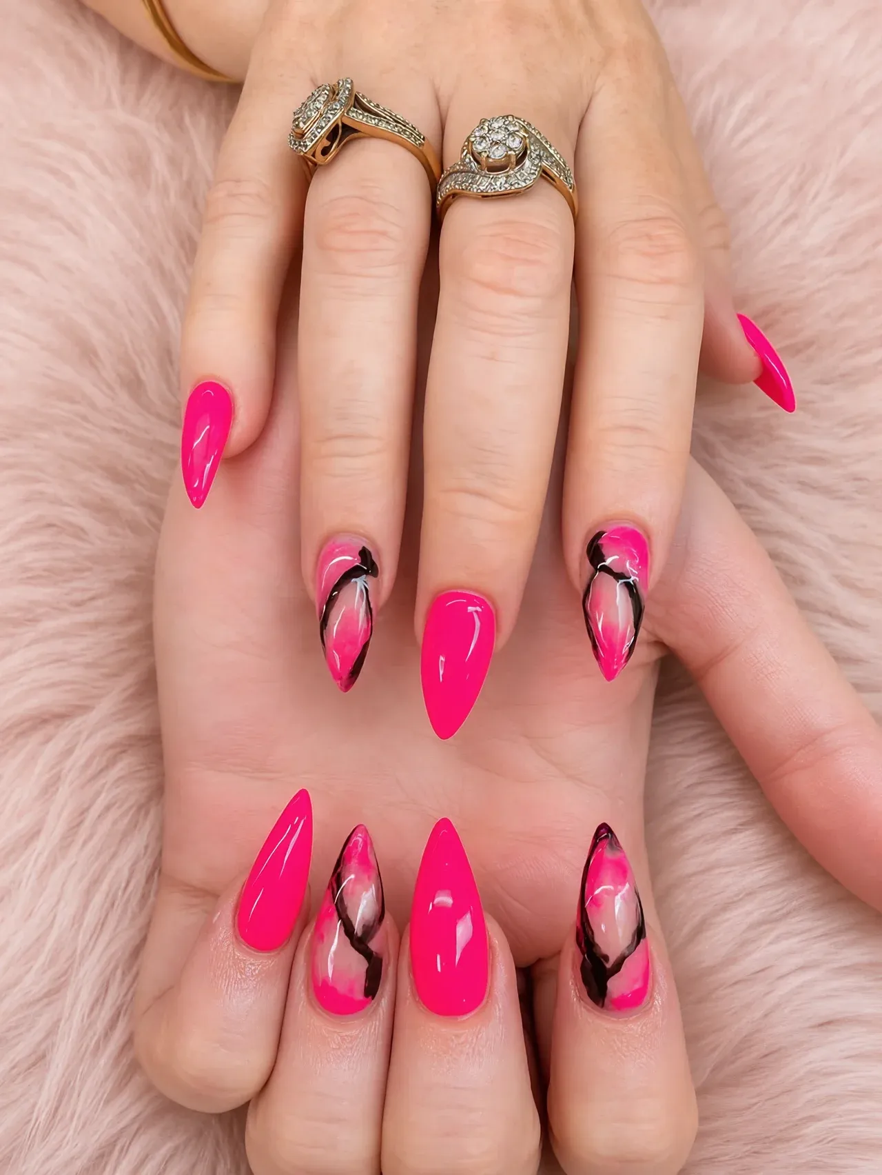 Hot-pink almond nails with black marble swirl accents