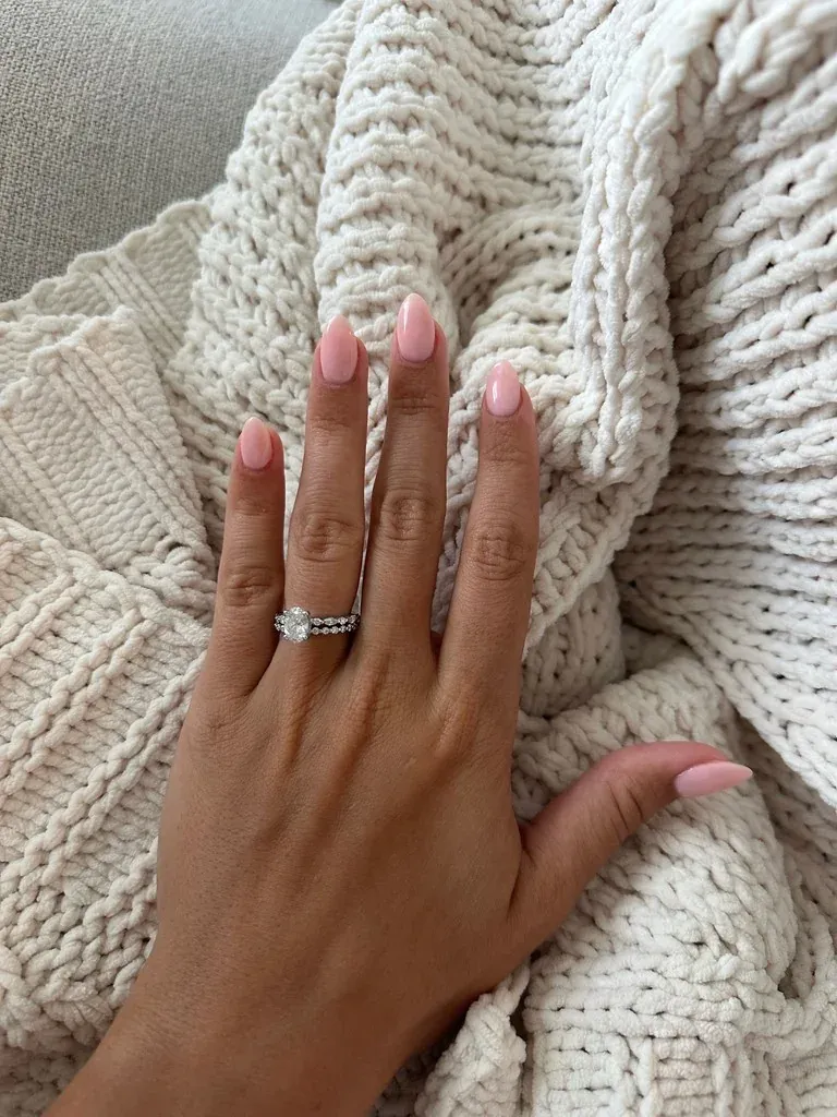 Soft pink builder gel manicure on almond-shaped nails with a glossy finish
